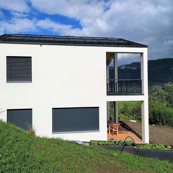 Die beiden versetzten Baukörper des Doppelhauses, vom Garten aus gesehen